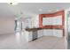 An open kitchen with stainless steel appliances, and breakfast bar. Features easy access to outdoor patio at 4918 Avon Ln, Sarasota, FL 34238