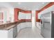 Bright kitchen with stainless steel appliances, granite countertops, white cabinets and tile floors at 4918 Avon Ln, Sarasota, FL 34238