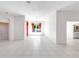 Bright, open living room with tile floors and arched doorways offers a spacious and airy feel at 4918 Avon Ln, Sarasota, FL 34238