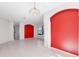 Open living space with tile flooring, archways, a red accent wall, and abundant natural light at 4918 Avon Ln, Sarasota, FL 34238