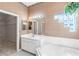 The main bathroom features a garden tub, separate shower, dual sinks, and decorative window at 4918 Avon Ln, Sarasota, FL 34238