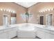 The main bathroom features a garden tub, separate shower, dual sinks, and decorative window at 4918 Avon Ln, Sarasota, FL 34238