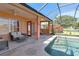 Relaxing outdoor pool area with seating and scenic pond views in a screened in enclosure at 4918 Avon Ln, Sarasota, FL 34238