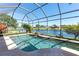 Sparkling pool overlooking a tranquil lake with a screened-in enclosure at 4918 Avon Ln, Sarasota, FL 34238