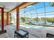 Outdoor pool area features an in-ground pool, screened enclosure and a beautiful pond view at 4918 Avon Ln, Sarasota, FL 34238
