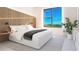 Bright bedroom with a large window and stylish décor with a wood panel accent wall at 4950 Remington Dr # 304, Sarasota, FL 34234