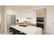 Modern kitchen with stainless steel appliances, stone counters, and a central island with barstool seating at 4950 Remington Dr # 304, Sarasota, FL 34234