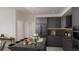 Dark modern kitchen features stainless appliances, an eat-in island, and complimentary dark stone counters at 4950 Remington Dr # 304, Sarasota, FL 34234
