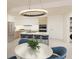 Modern kitchen with stainless steel appliances, island with bar seating and elegant lighting fixture at 4950 Remington Dr # 304, Sarasota, FL 34234