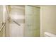 Bathroom shower with glass doors and accessibility grab bars offer safety and style at 525 Barcelona Ave # 207, Venice, FL 34285