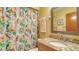 Stylish bathroom featuring granite countertop and a vibrant, patterned shower curtain at 525 Barcelona Ave # 207, Venice, FL 34285