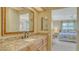 Main bathroom featuring granite countertops, updated vanity, and a view into the main bedroom at 525 Barcelona Ave # 207, Venice, FL 34285