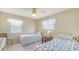 Sunlit bedroom featuring two beds, ceiling fan, and serene, inviting atmosphere at 525 Barcelona Ave # 207, Venice, FL 34285