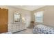 Bright bedroom with twin beds, closet, and dresser, flooded with natural light at 525 Barcelona Ave # 207, Venice, FL 34285
