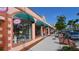 Downtown shops with pink awnings and window displays of local boutiques at 525 Barcelona Ave # 207, Venice, FL 34285