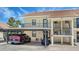 View of the building's exterior, showcasing the covered parking, and the upstairs balconies at 525 Barcelona Ave # 207, Venice, FL 34285
