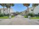 Charming exterior view of the property with palm trees and inviting entrance at 525 Barcelona Ave # 207, Venice, FL 34285