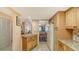 Open kitchen layout with granite countertops and view into the living and dining areas at 525 Barcelona Ave # 207, Venice, FL 34285