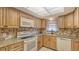 Updated kitchen with granite countertops, stone backsplash, and stainless steel appliances at 525 Barcelona Ave # 207, Venice, FL 34285
