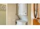 A compact laundry area featuring stacked washer and dryer units for convenience at 525 Barcelona Ave # 207, Venice, FL 34285