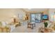 Inviting living room features comfortable seating, and access to the outdoor patio at 525 Barcelona Ave # 207, Venice, FL 34285