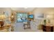 Cozy living room with comfortable seating, a glass coffee table and access to a patio at 525 Barcelona Ave # 207, Venice, FL 34285