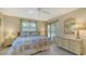 Comfortable main bedroom with sliding glass door, ceiling fan, and neutral decor at 525 Barcelona Ave # 207, Venice, FL 34285