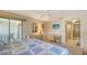 Spacious main bedroom featuring a ceiling fan, balcony access, and ample closet space at 525 Barcelona Ave # 207, Venice, FL 34285