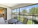 Cozy screened patio with outdoor seating offers a relaxing outdoor space at 525 Barcelona Ave # 207, Venice, FL 34285