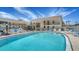 Community pool with lounge chairs and a secure surrounding fence at 525 Barcelona Ave # 207, Venice, FL 34285