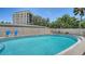 A refreshing swimming pool surrounded by a privacy fence and outdoor seating at 525 Barcelona Ave # 207, Venice, FL 34285