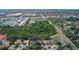 An aerial view of a property with a mature tree-lined greenbelt backyard and a swimming pool at 5355 Anthony Ln, Sarasota, FL 34233