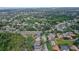 A neighborhood aerial view showcasing mature landscaping, a community layout, and nearby roads at 5355 Anthony Ln, Sarasota, FL 34233