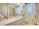 Bathroom featuring a tub and shower combination, a large mirror, and bright lighting at 5355 Anthony Ln, Sarasota, FL 34233