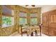 Charming breakfast nook bathed in natural light, with views of lush greenery and decorative wallpaper at 5355 Anthony Ln, Sarasota, FL 34233