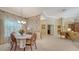Elegant dining room featuring a chandelier, decorative wallpaper, and access to the living area at 5355 Anthony Ln, Sarasota, FL 34233