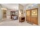 Traditional dining room with wood furnishings, decorative wallpaper, and natural light from the front door at 5355 Anthony Ln, Sarasota, FL 34233