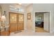 Elegant foyer featuring double doors, decorative accents, and a glimpse into the living room area with floral wallpaper at 5355 Anthony Ln, Sarasota, FL 34233