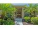 Elegant front entrance featuring double wooden doors, decorative wreaths, and manicured landscaping at 5355 Anthony Ln, Sarasota, FL 34233