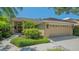 Charming single-story home with a tile roof, lush landscaping, and a two-car garage in a tropical setting at 5355 Anthony Ln, Sarasota, FL 34233