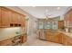Functional kitchen with wood cabinets, granite countertops, and a built-in desk area at 5355 Anthony Ln, Sarasota, FL 34233