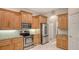 Modern kitchen featuring stainless steel appliances, wood cabinets, and ample countertop space at 5355 Anthony Ln, Sarasota, FL 34233