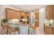 Well-equipped kitchen with wooden cabinetry, granite countertops, and a convenient breakfast bar at 5355 Anthony Ln, Sarasota, FL 34233