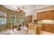 Charming eat-in kitchen nook with backyard views, tropical wallpaper, and wood furnishings at 5355 Anthony Ln, Sarasota, FL 34233