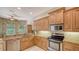 Well-lit kitchen featuring granite countertops, stainless steel appliances, and ample cabinet space at 5355 Anthony Ln, Sarasota, FL 34233