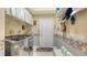 Functional laundry room featuring a washer, dryer, shelving, and stylish wallpaper accents at 5355 Anthony Ln, Sarasota, FL 34233