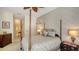 Comfortable main bedroom with a four-poster bed, decorative accents, and access to the hallway at 5355 Anthony Ln, Sarasota, FL 34233