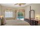 Comfortable bedroom featuring access to the pool area, natural light, and a decorative ceiling fan at 5355 Anthony Ln, Sarasota, FL 34233