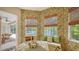Breakfast nook features tropical wallpaper, backyard view, and cozy built-in bench seating at 5355 Anthony Ln, Sarasota, FL 34233