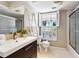 Charming bathroom featuring modern vanity, ladder towel rack, and tiled shower with glass doors at 5432 Cape Leyte Dr, Sarasota, FL 34242